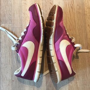 Nike pink tennis shoes with white swoosh, size 7.